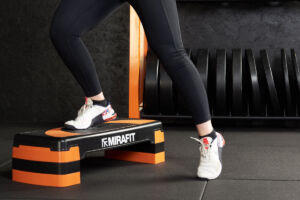 Woman using a Mirafit Aerobic Exercise Step