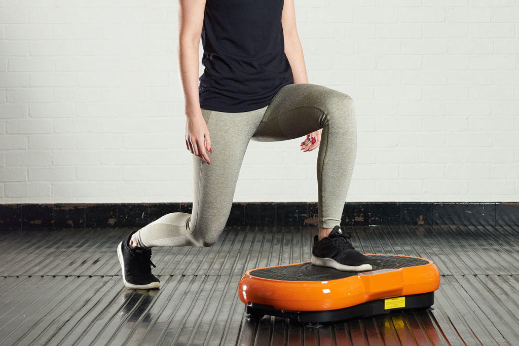 Mirafit Slimline Vibration Plate Woman lunging on a Mirafit Slimline Vibration Plate