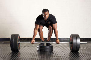 Man doing a deficit deadlift with Mirafit weight plates