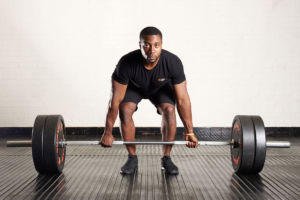 Man doing a standard deadlift using a Mirafit M3 7ft 20kg Olympic Barbell
