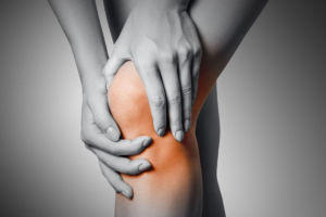 A woman suffering from knee pain from squatting