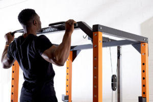fitness expert does a chin up on a mirafit power rack