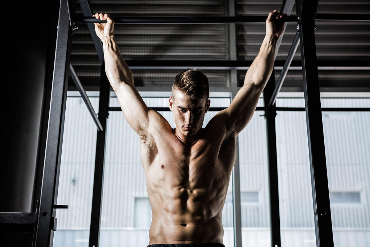 Man deadhanging from a Pull Up Bar