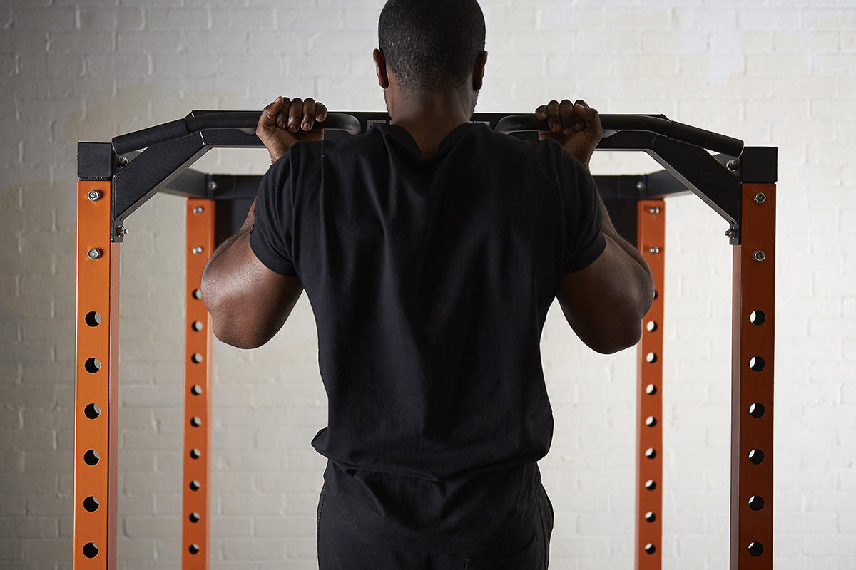 Mirafit fitness expert doing a chin up on a Mirafit power cage