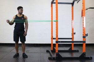 Man doing a lateral external rotation with a Mirafit resistance band