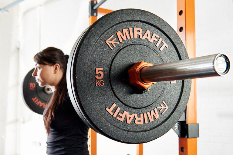 fitness expert using mirafit barbell and bumper plates