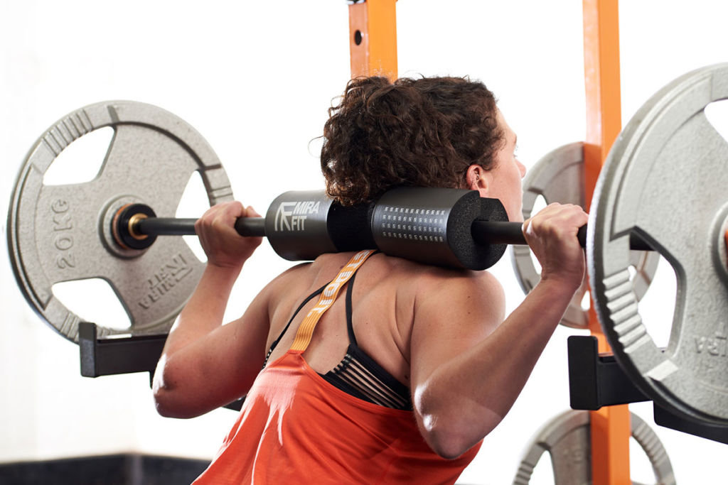 Woman squatting with 20kg weight plates