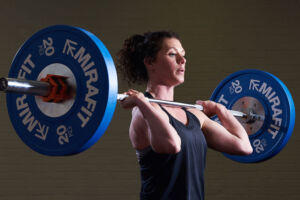 Woman does a clean and jerk with a Mirafit Barbell