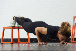 Woman doing a decline push up using a Mirafit Steel Plyo Jump Box