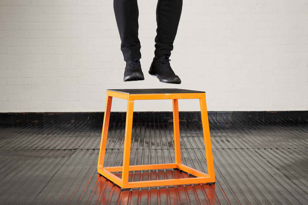 Man doing a box jump on a Mirafit Steel Plyo Jump Box