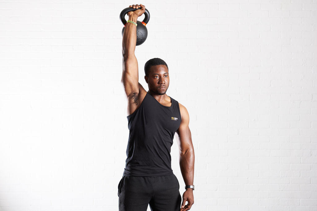 Kettlebell press Man doing a kettlebell press with a Mirafit Cast Iron Kettlebell