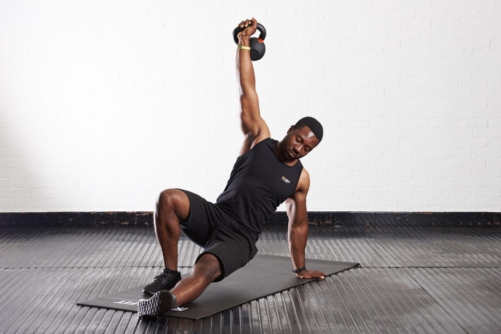 Turkish get up Man doing a Turkish Get Up with a Mirafit Cast Iron Kettlebell
