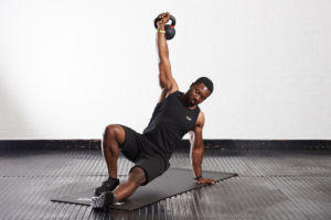 Man doing a Turkish Get Up with a Mirafit Cast Iron Kettlebell