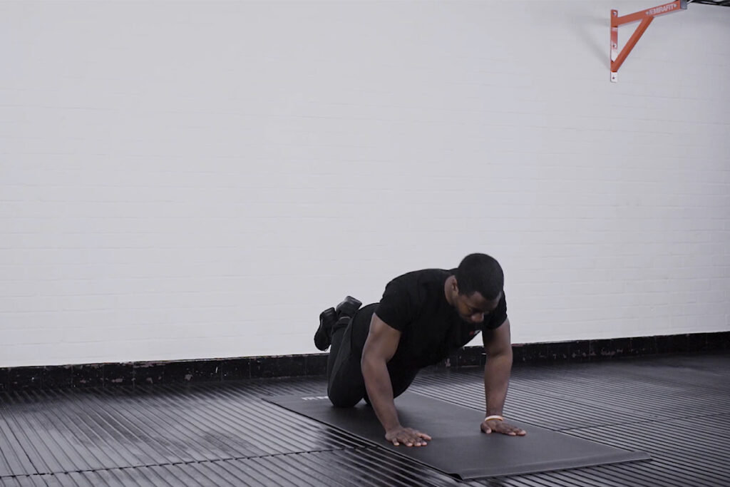 Knee Press Up Man performing a knee press up