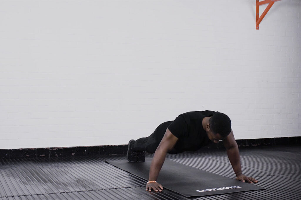 Wide Press Up Man performing a wide press up