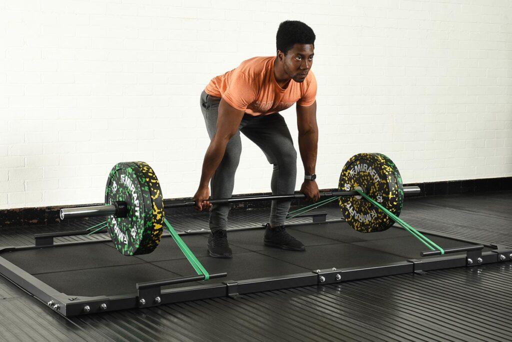 Mirafit Resistance Bands Man performing a deadlift on a Mirafit deadlift platform with Mirafit Resistance Bands