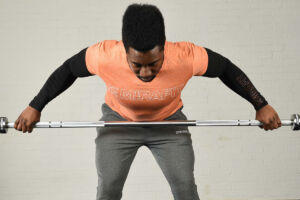 Man doing a wide grip bent over row with a Mirafit Olympic barbell