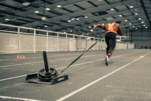 Harry-Aikines-Sprinting-While-Pulling-Weighted-Mirafit-Drag-Sled