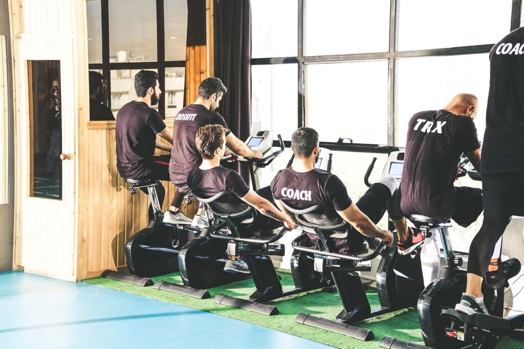 Exercise bikes Group of men working out on stationary bikes in a gym