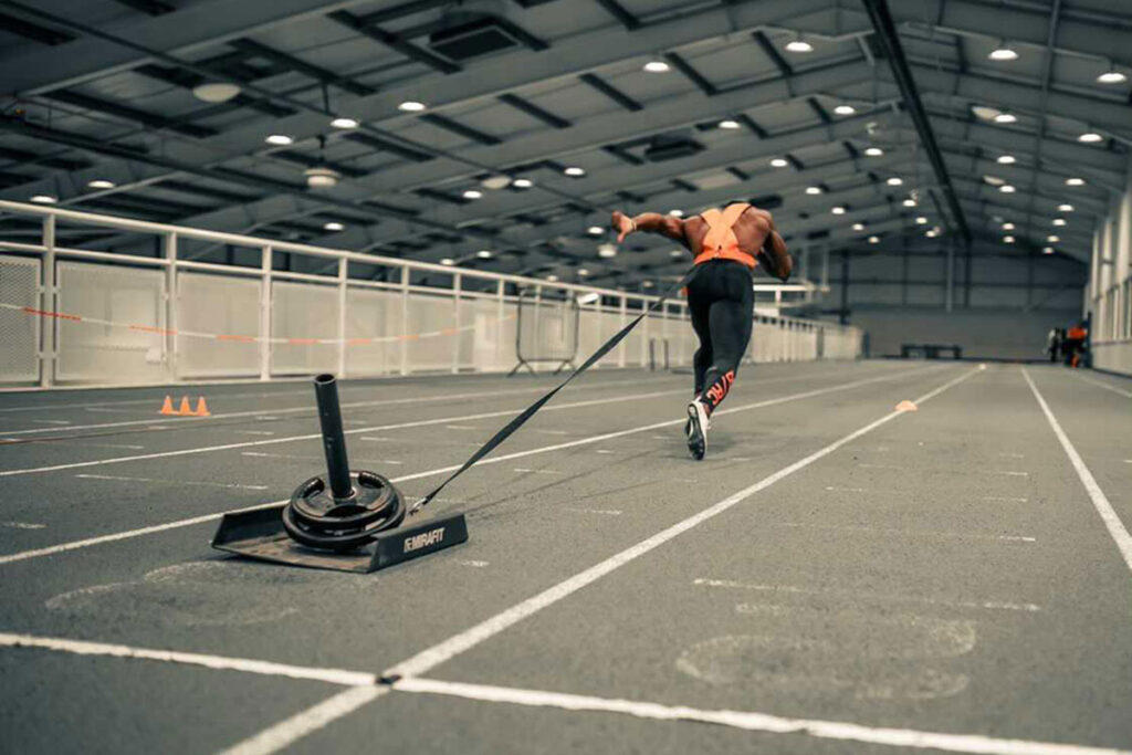 Mirafit Weight Drag Sled & Harness Harry Aikines-Aryeetey sprinting with a Mirafit Weight Drag Sled & Harness