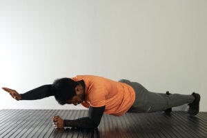 Man performing a single arm plank
