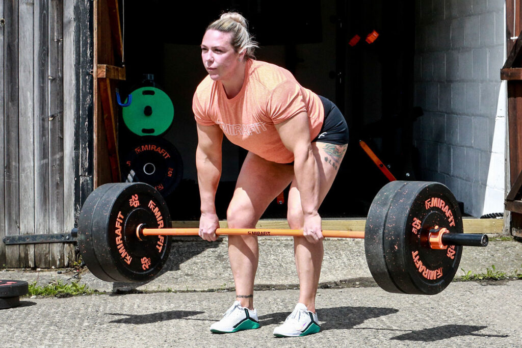 Former World's Strongest Woman Donna Moore performing a deadlift with a Mirafit Women's Olympic Bar