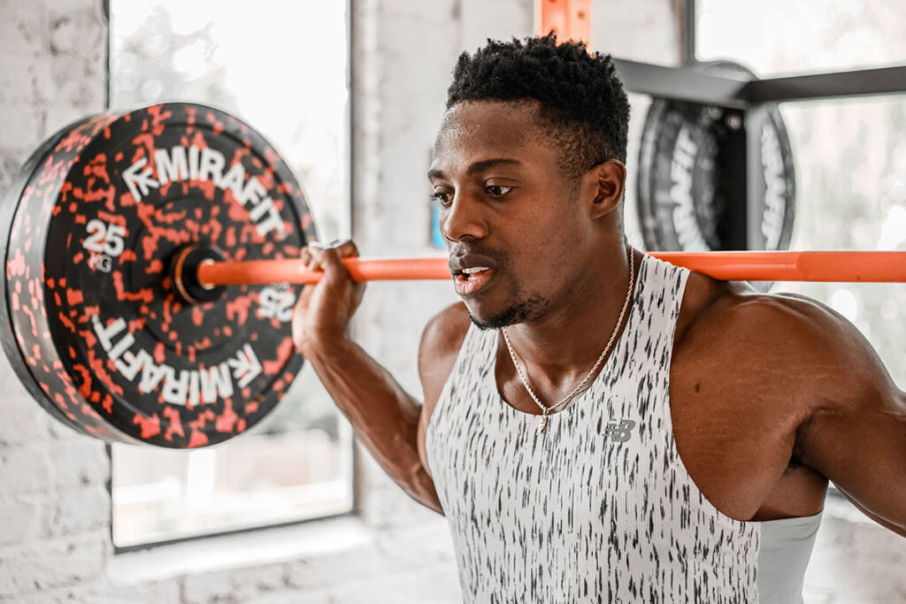 Mirafit Colour Splash Bumper Plates - 25kg Weight Plates Team GB Olympic Sprinter Harry AA in his home gym with Mirafit barbells and Mirafit colour splash bumper plates