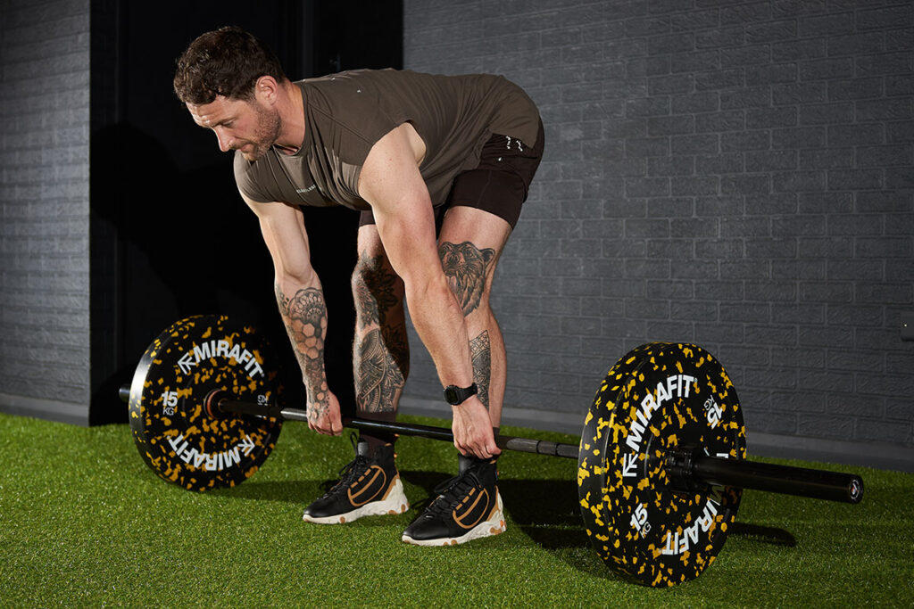 Fitness expert Jay Wall demonstrates a Barbell Row with a pair of Mirafit colour splash 15kg plates.