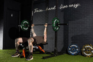 Fitness expert Jay Wall performing a Bench Press with Mirafit 10kg weight plates