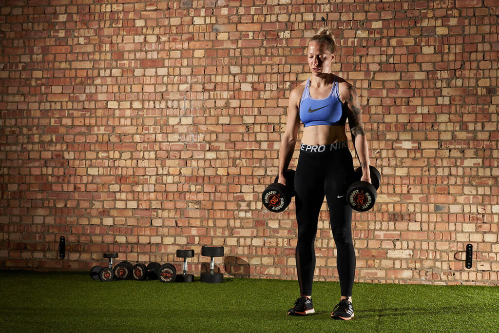 Mirafit Rubber Dumbbell Set - 20kg Dumbbells Woman performing a deadlift with a pair of Mirafit 20kg dumbbells