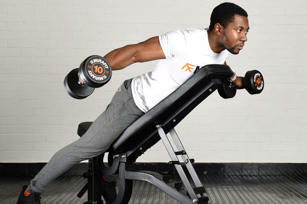Man performing reverse Dumbbell Flyes with Mirafit 10kg dumbbells