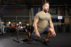 Man performing a bodyweight split squat with the Mirafit Single Leg Split Squat Stand