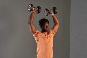 Man doing a dumbbell shoulder press with Mirafit 7.5kg Dumbbells