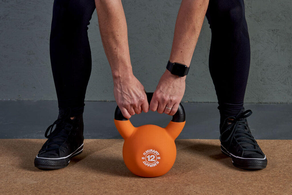 Kettlebell deadlift Woman deadlifting a 12kg Kettlebell
