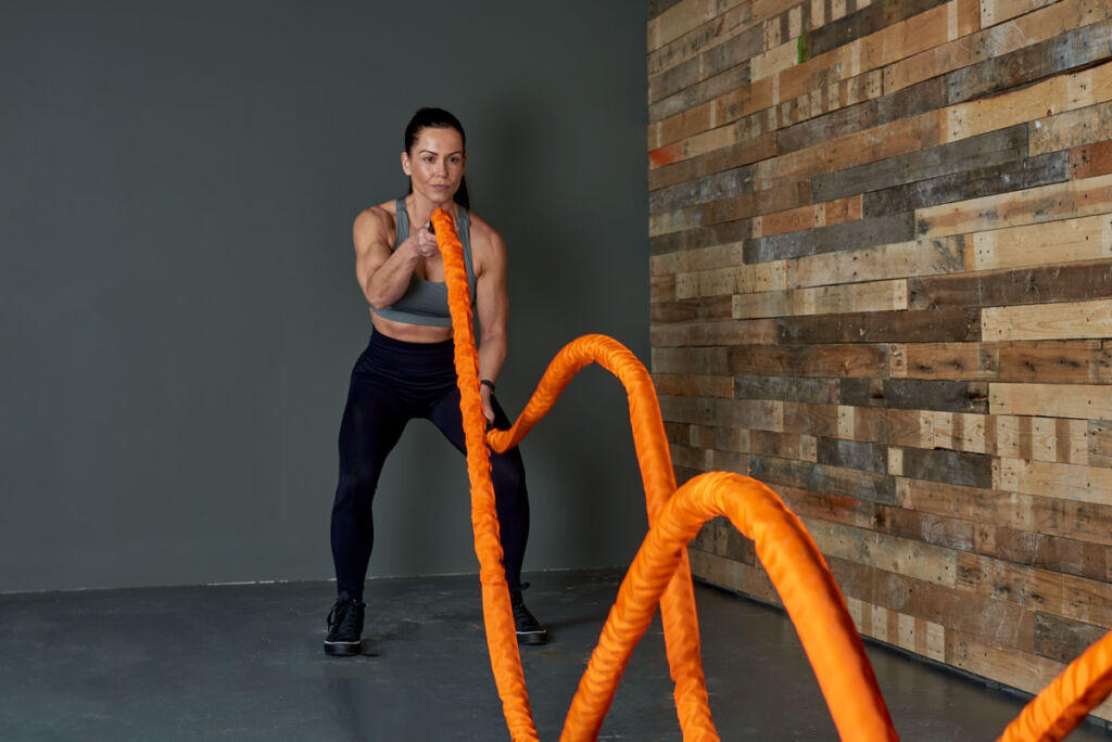 Mirafit Sleeve Battle Rope Woman using an orange Mirafit Sleeve Battle Rope