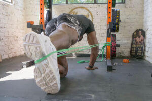 Harry Aikines Aryeetey performing glute activation exercises with a Mirafit Resistance Band