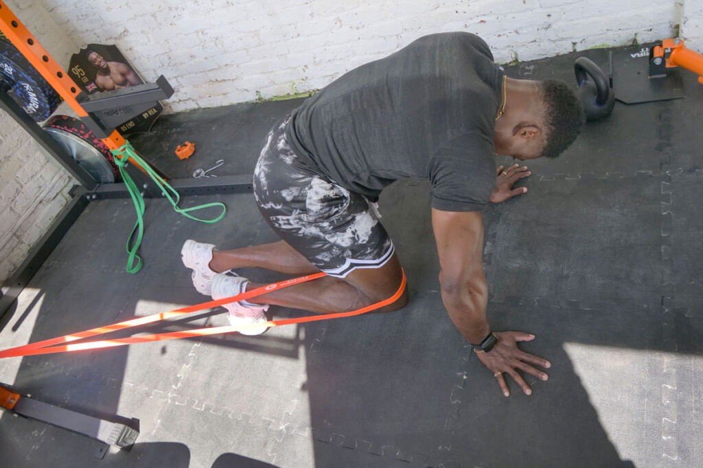 Hip flexor activation Harry Aikines-Aryeetey performing hip flexor exercises with Mirafit Resistance Band