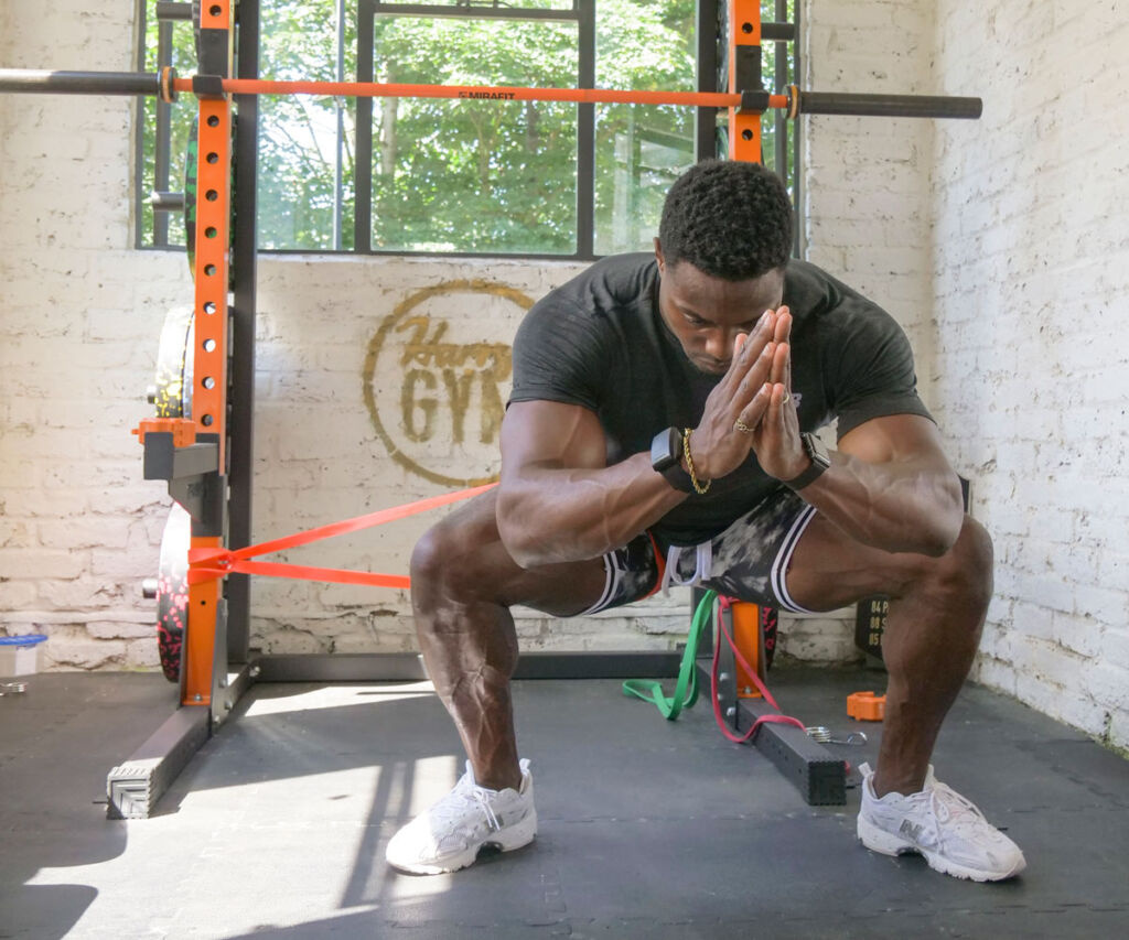 Squat with banded interference Harry Aikines-Aryeetey performing squat exercises with Mirafit Resistance Band