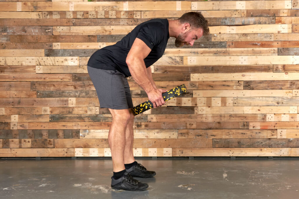 Man performing a bent over row with a Mirafit 15kg Weight Plate
