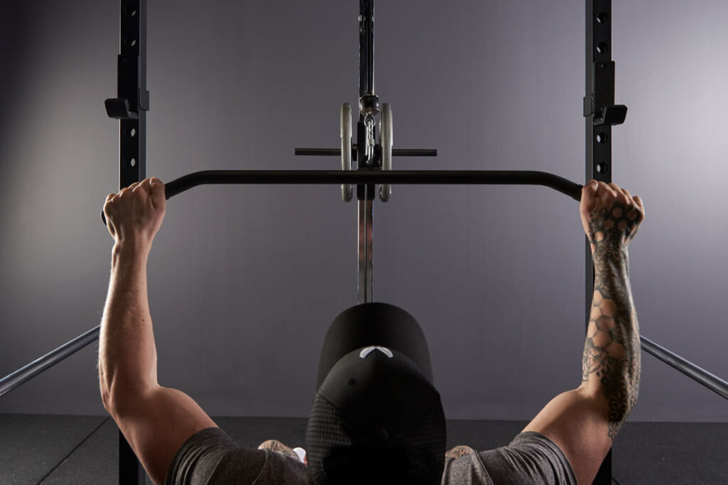 Mirafit Fitness Specialist Performing a Lat Pull Down on a Power Rack