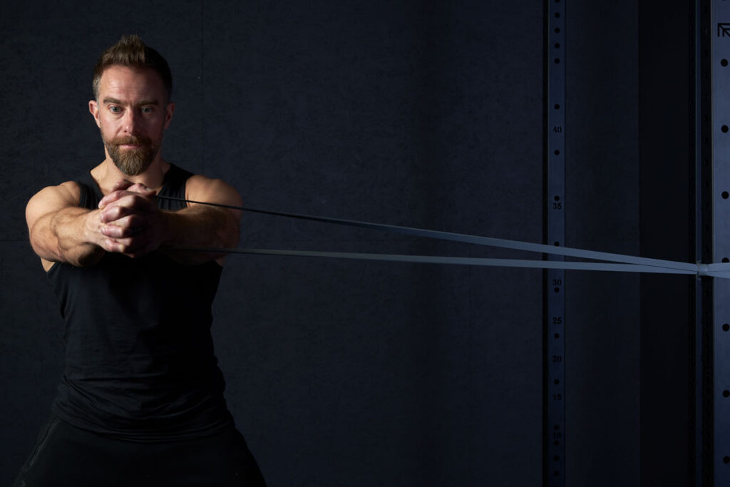 Mirafit Resistance Bands Fitness professional Performing a Palloff Press Using a Mirafit Resistance Band