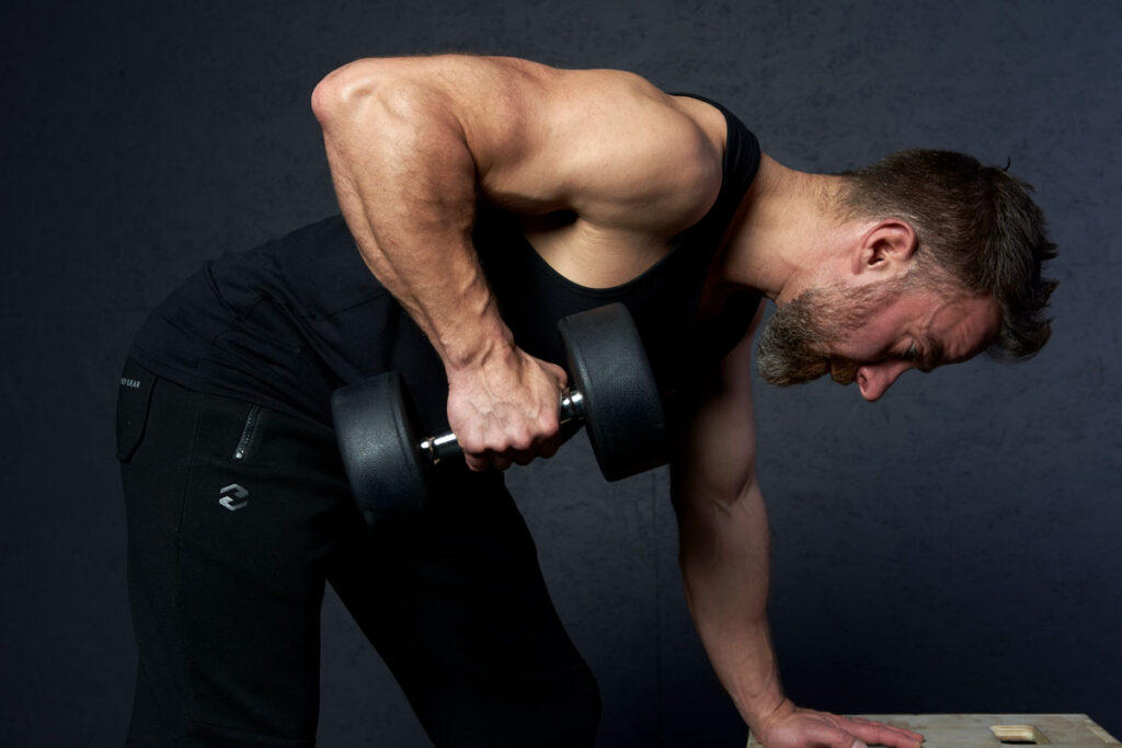 Mirafit Rubber Dumbbell Set Fitness Specialist Performing a Dumbbell Row using Mirafit dumbbells