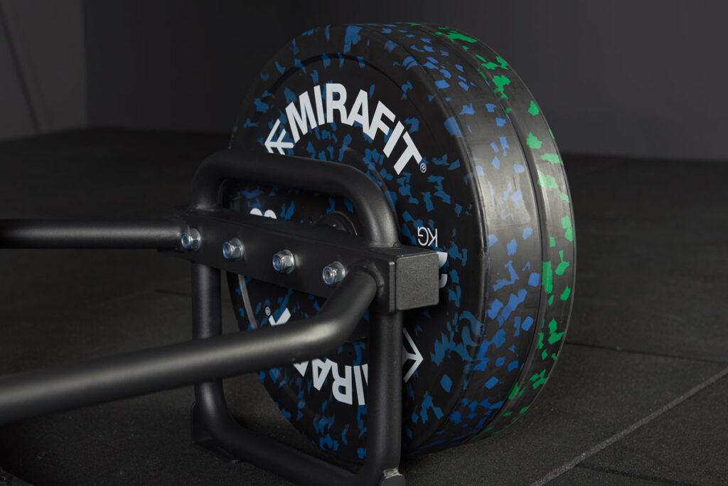Close up view of 10kg weight plates and 20kg weight plates on a Mirafit trap bar