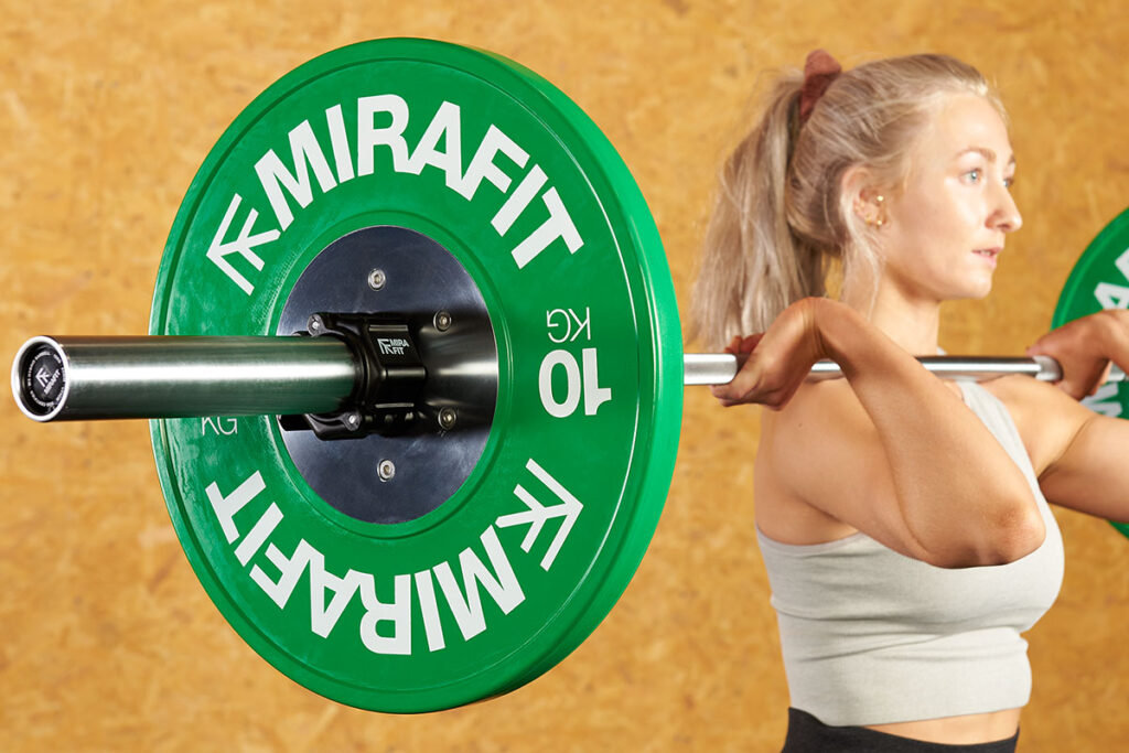 Fitness Professional Performing Front Squats Using a Mirafit Women's  Olympic Barbell