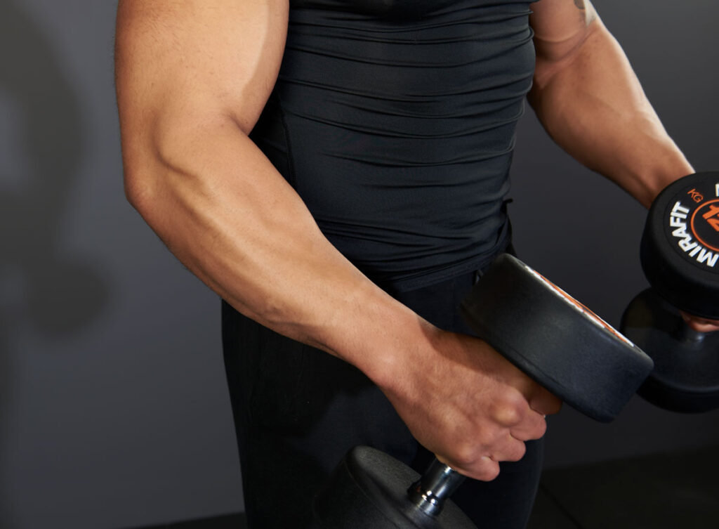 Mirafit Rubber Dumbbell Set - 12.5kg Dumbbells Man performing dumbbell Lat Raises with Mirafit Rubber 12.5kg Dumbbells