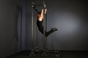 man performing a kipping pull up on a Mirafit M3 Half Rack