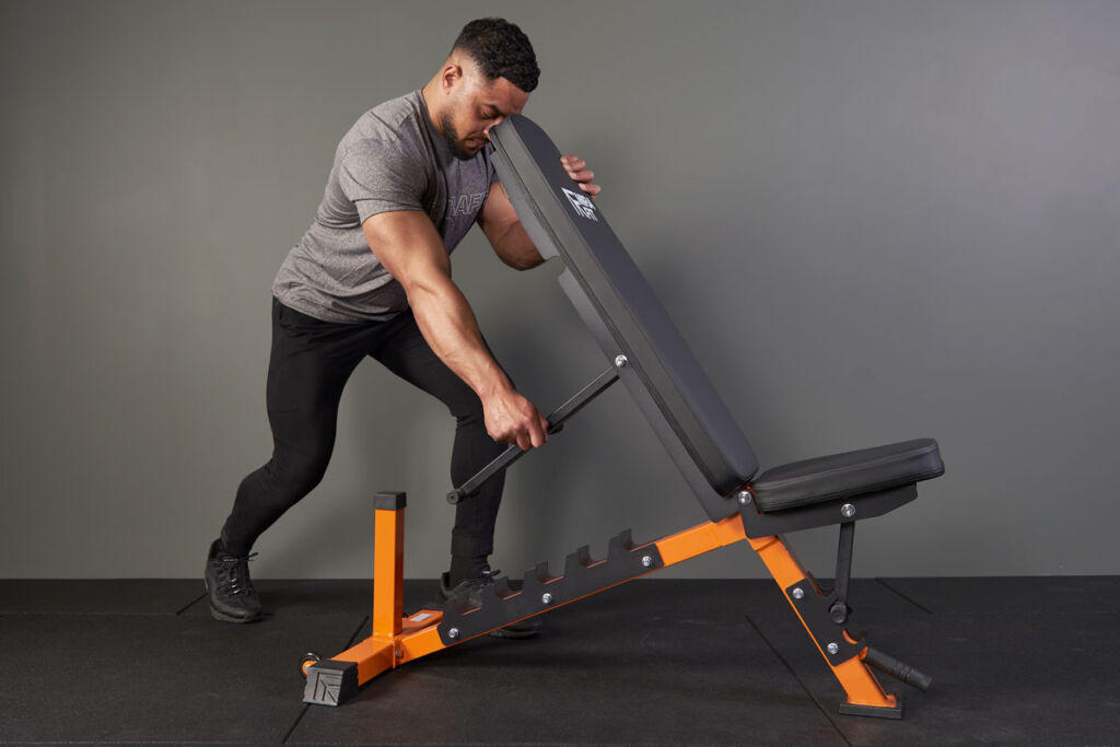 Man adjusting a Mirafit M250 Adjustable Weight Bench
