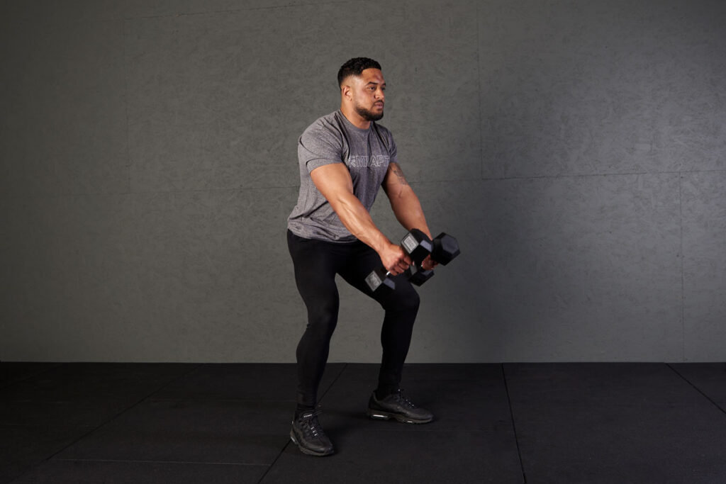 Man performing a Devil press using Mirafit hex dumbbells