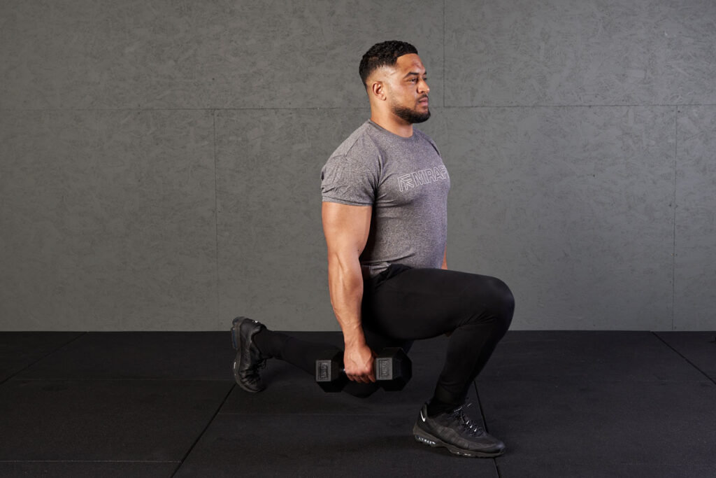 Man performing walking lunges using Mirafit hex dumbbells
