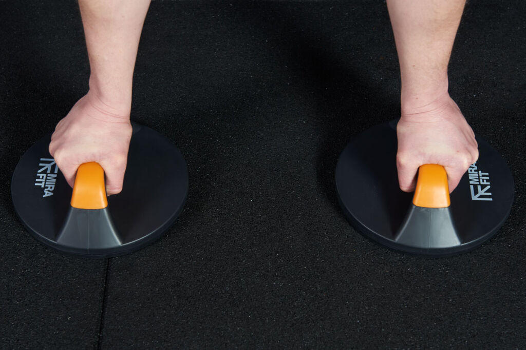 Mirafit Rotating Push Up Bars Woman performing a push up using Mirafit Rotating Push Up Bars